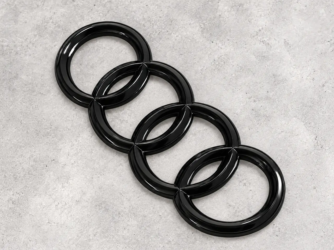 Cuatro aros negros de acabado brillante impresos en 3D
